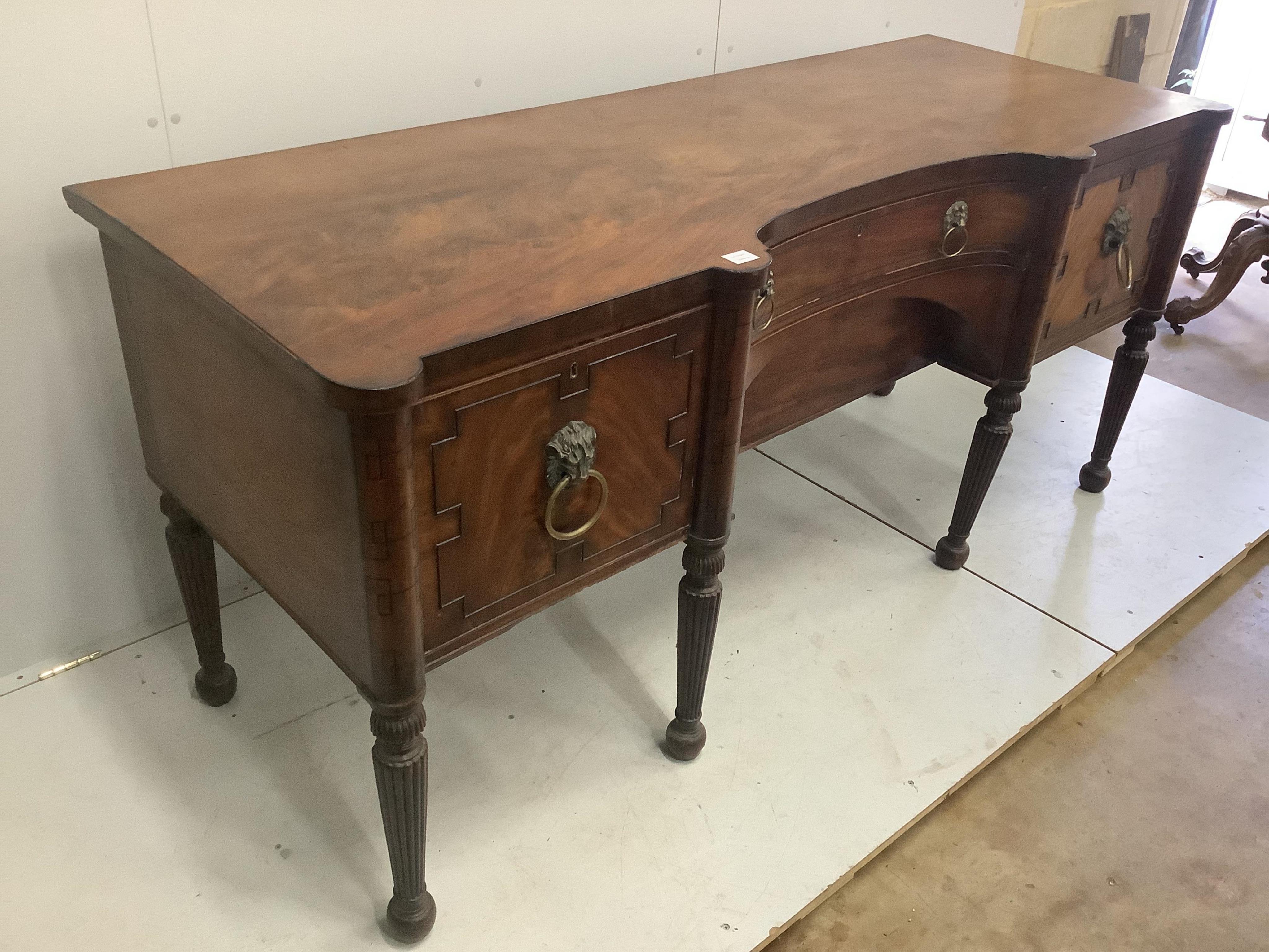 A Regency mahogany sideboard, with a concave front, width 199cm, depth 76cm, height 90cm. Condition - fair